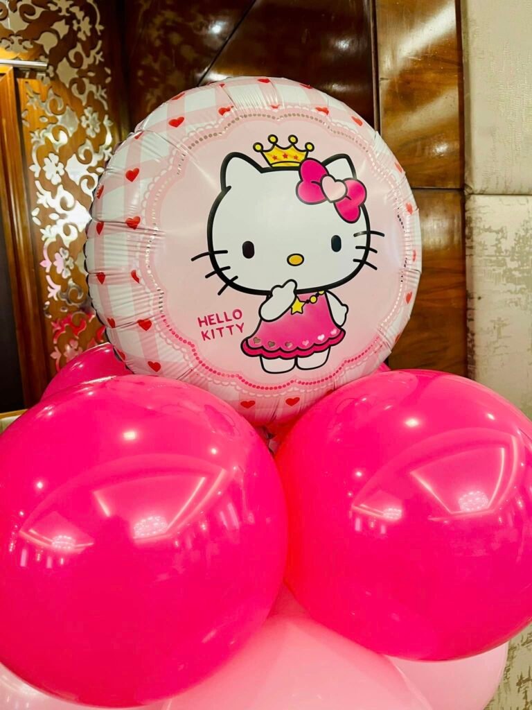 Princess Hello Kitty foil balloon with a crown on top of hot pink balloons
