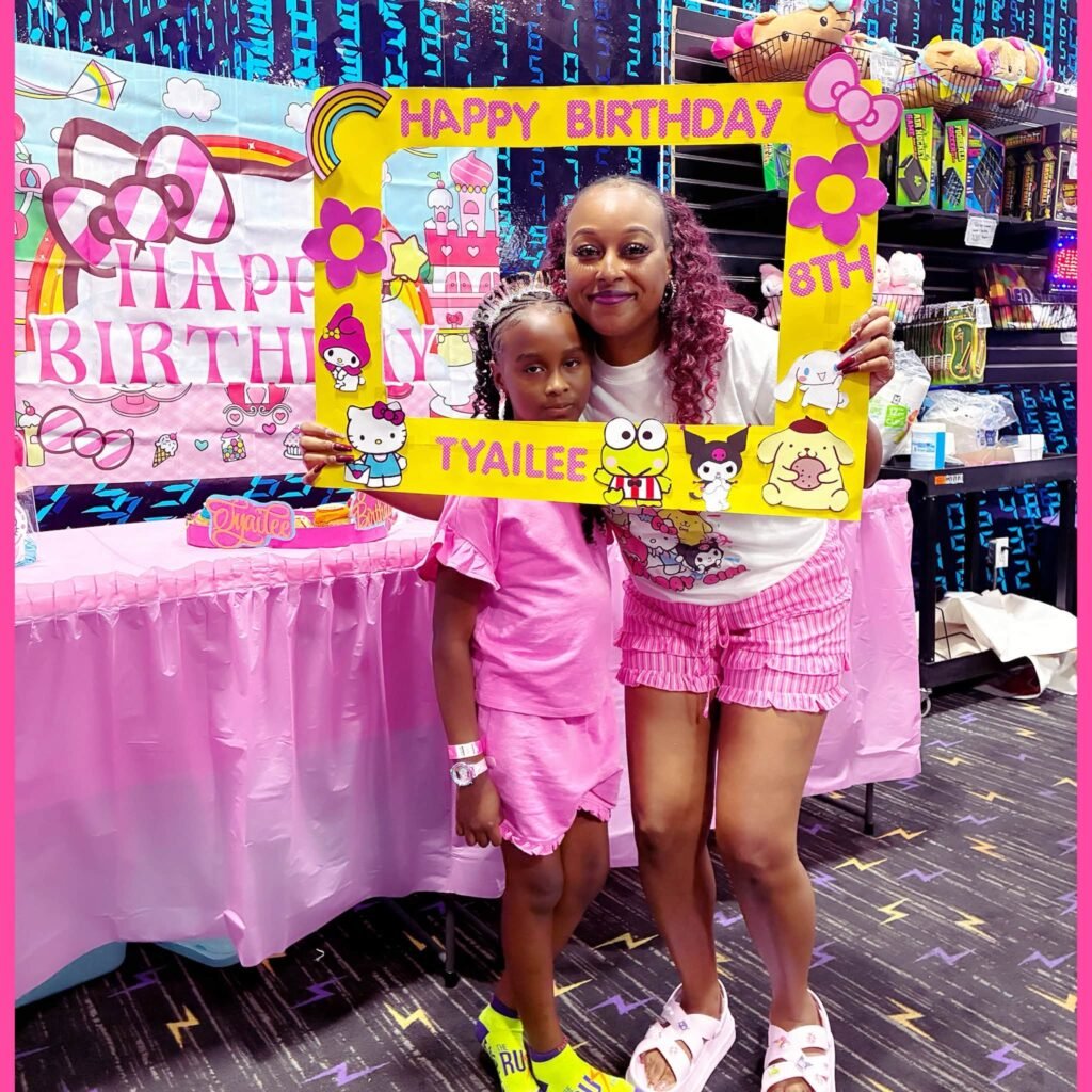 Happy birthday photo frame prop with Hello Kitty and Sanrio friends at a pink party table