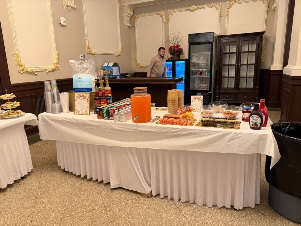 Drink and dessert table with a white skirt at a pumpkin baby shower