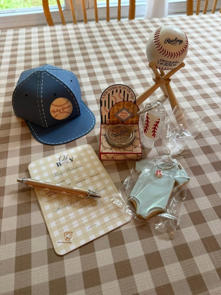 Baseball baby shower guest book table with a denim cap, a pen and a baseball