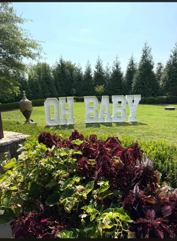 Oh Baby marquee letters on a green lawn for a boy baby shower
