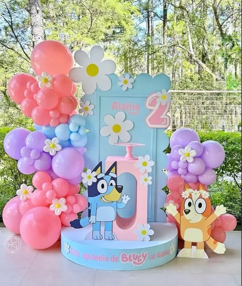 Pastel Bluey 2nd birthday backdrop with pink, lilac and blue balloons, white daisies, a number 2 and Bluey and Bingo cutouts