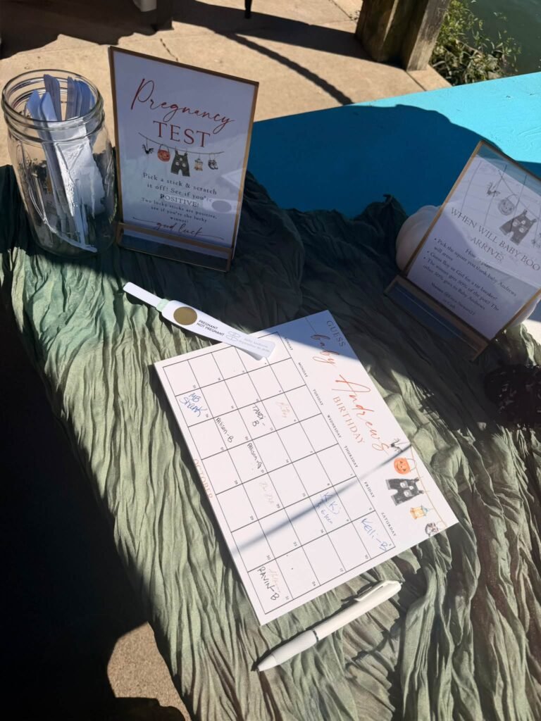 Pregnancy test guessing game sign with a jar of cards at a Halloween baby shower