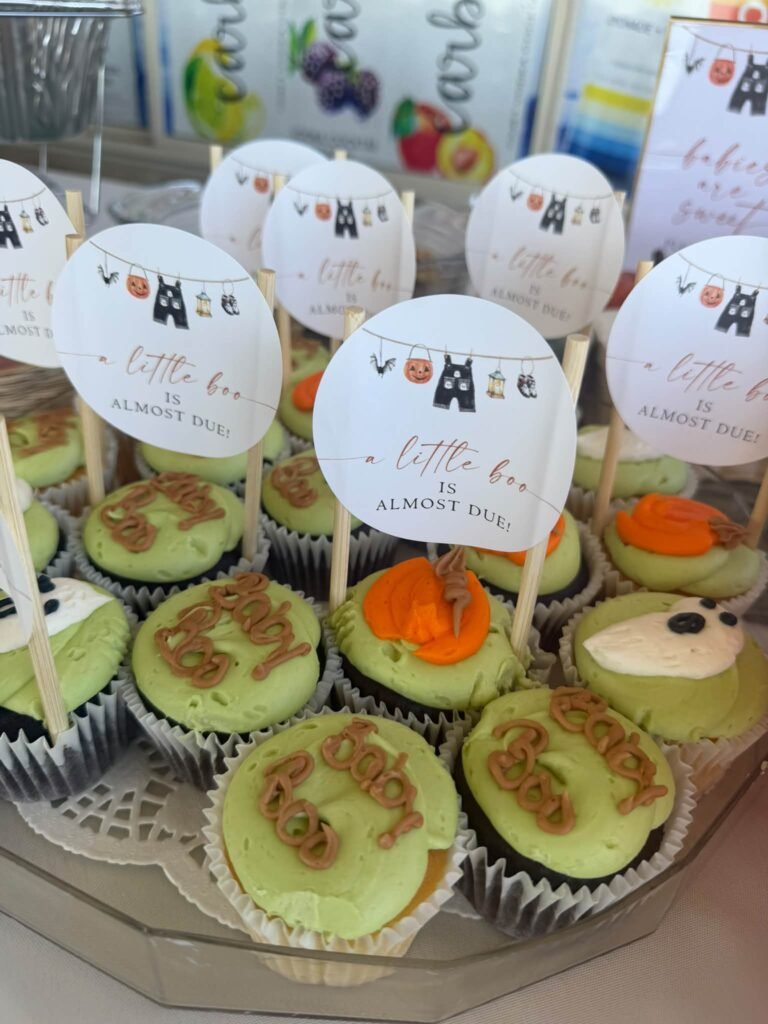 Little Boo baby shower cupcakes with green frosting, piped baby boo letters, ghost toppers and round Little Boo is almost due picks