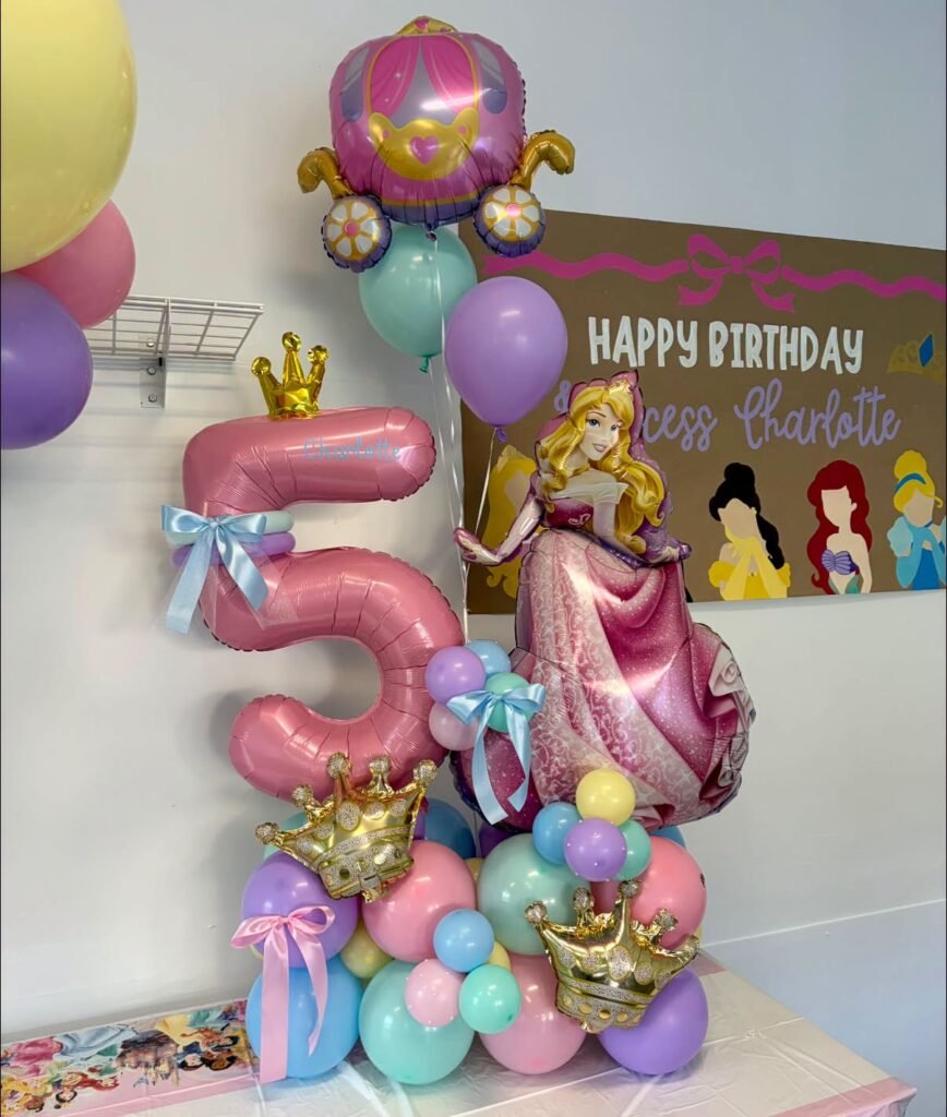 Disney Princess 5th birthday balloon tower with a pink number 5, princess foil balloons and gold crowns