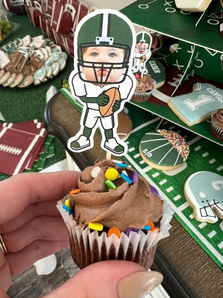 Chocolate cupcake with a football player topper that shows the birthday baby's face