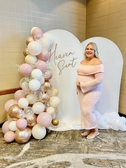 Mom to be in a blush off shoulder dress by a Heaven Sent backdrop