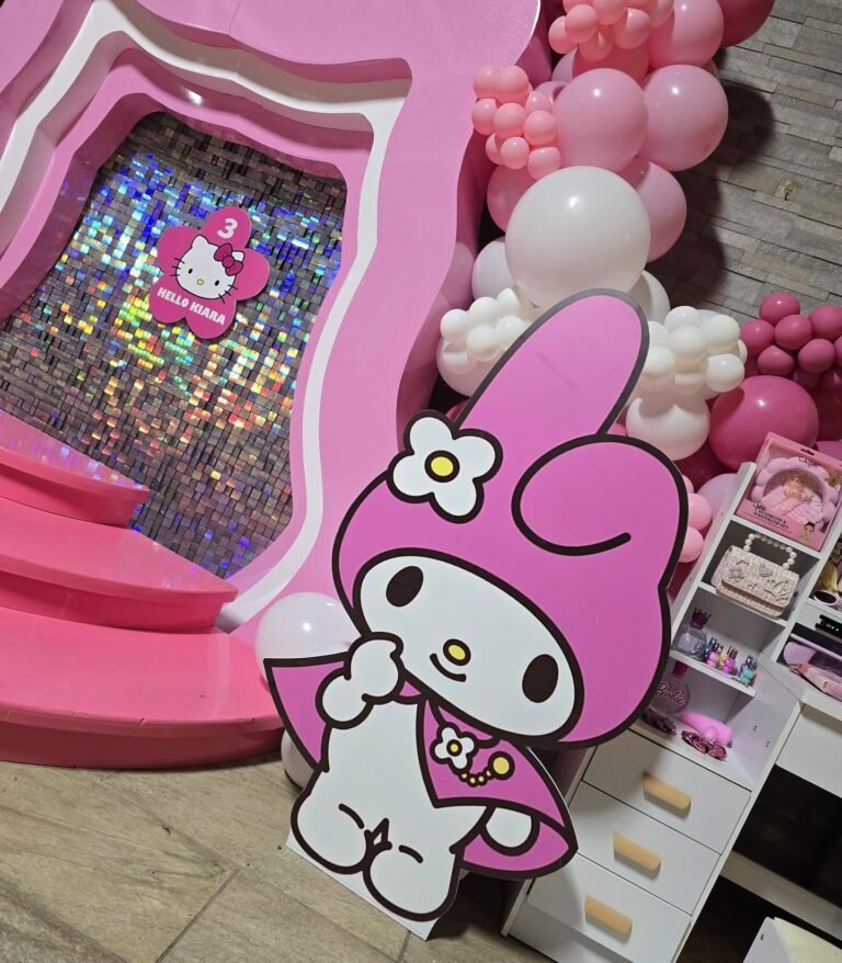 My Melody cutout next to a pink round stage and a shimmer wall with pink balloons