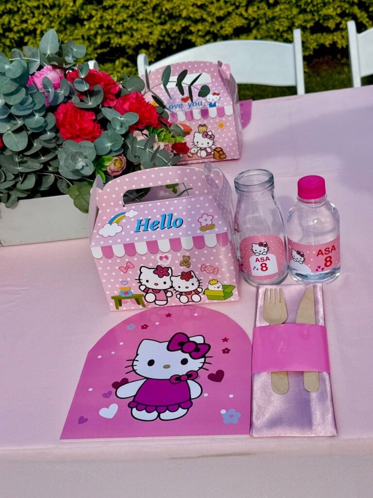 Hello Kitty treat box next to custom labeled water bottles on a pink table