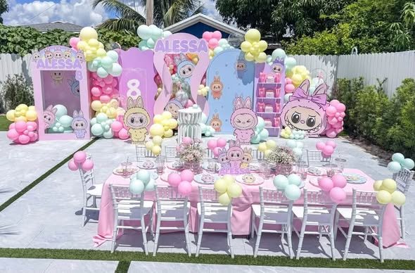 Outdoor pastel Labubu party with a balloon backdrop and a long kids table