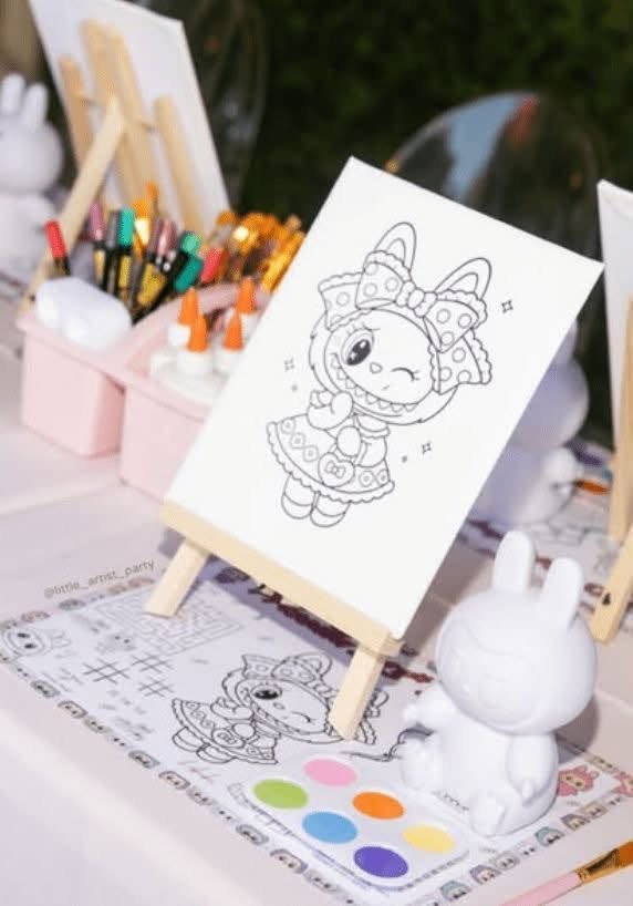 Labubu coloring station with a coloring page on a mini easel and paint palettes