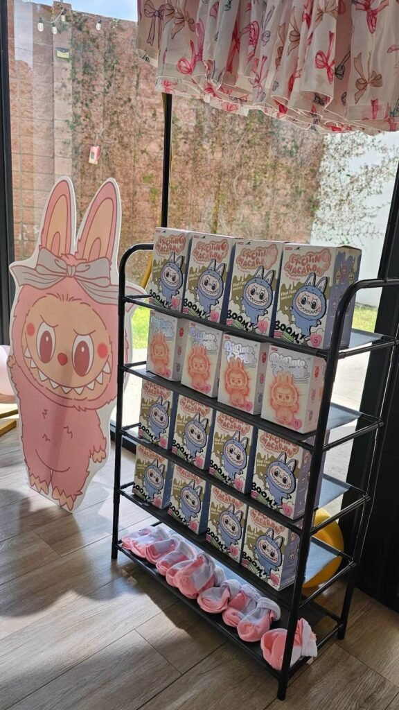 Labubu cutout next to a rack of boxed Labubu figures as a party display