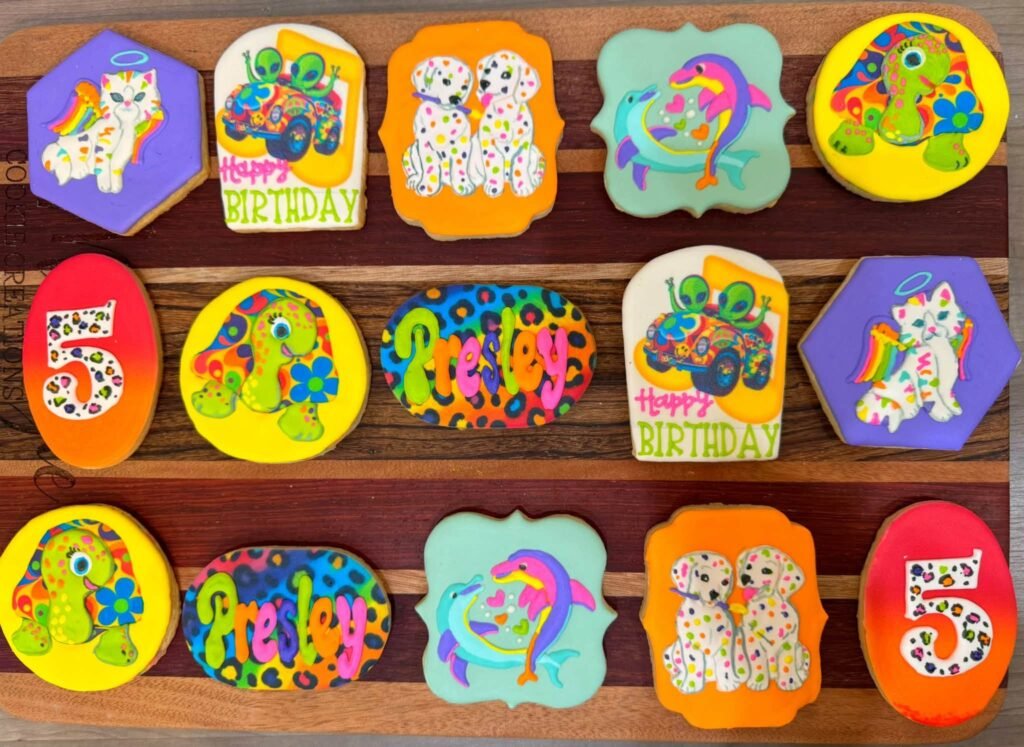 Custom Lisa Frank style cookies with rainbow leopards, dolphins, unicorns, the number 5 and Happy Birthday