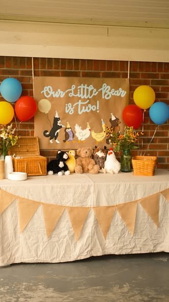 Little Bear birthday dessert table with a burlap tablecloth and animal friends