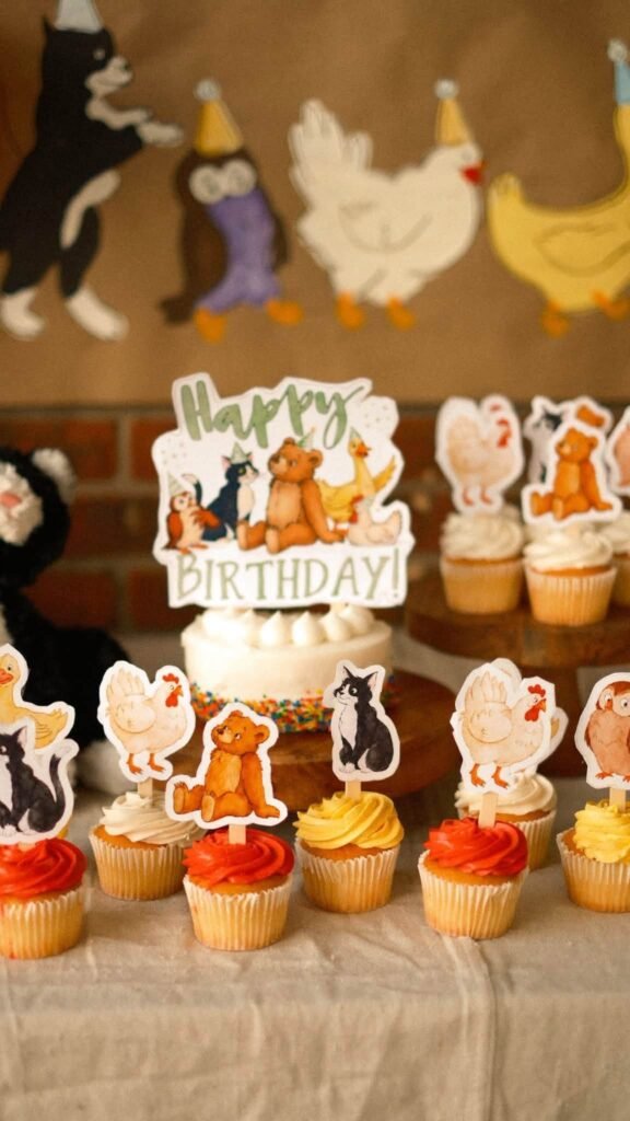 Cupcakes with Little Bear animal character toppers on a wood stand