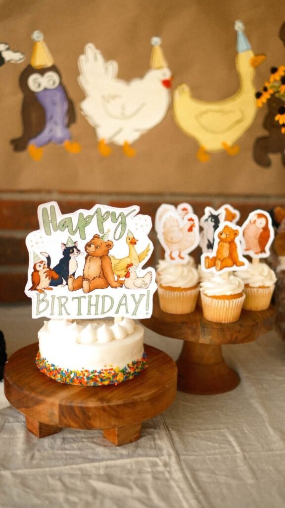 Little Bear birthday cake with a Happy Birthday topper and animal character cutouts