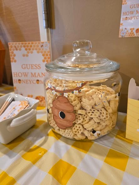 Guess how many honeycombs game with a big glass jar of Honeycomb cereal and a bee hive label