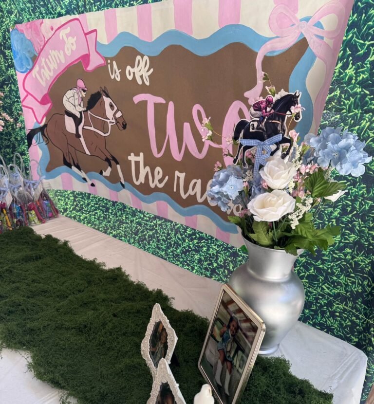 Off Two the Races sign on a green hedge backdrop with horse illustrations