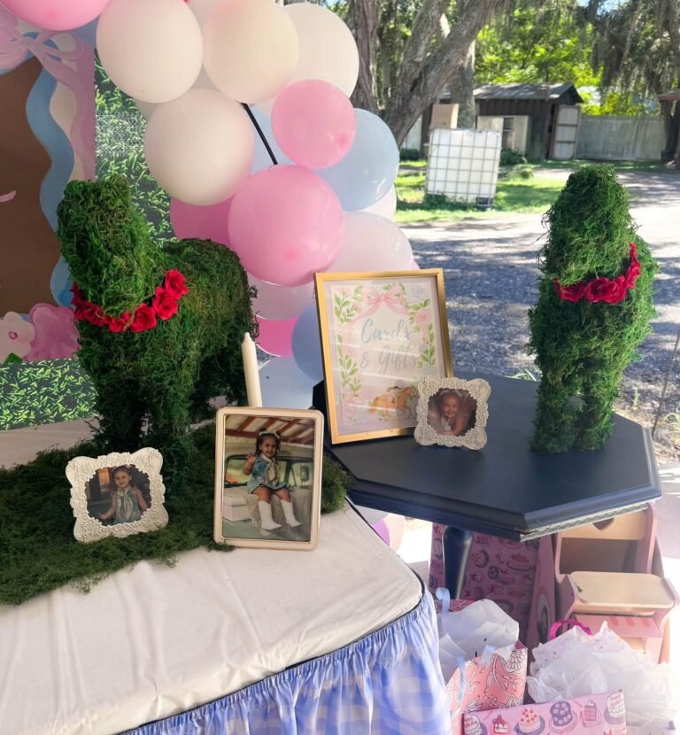 Topiary horses and framed horse prints on a derby party table