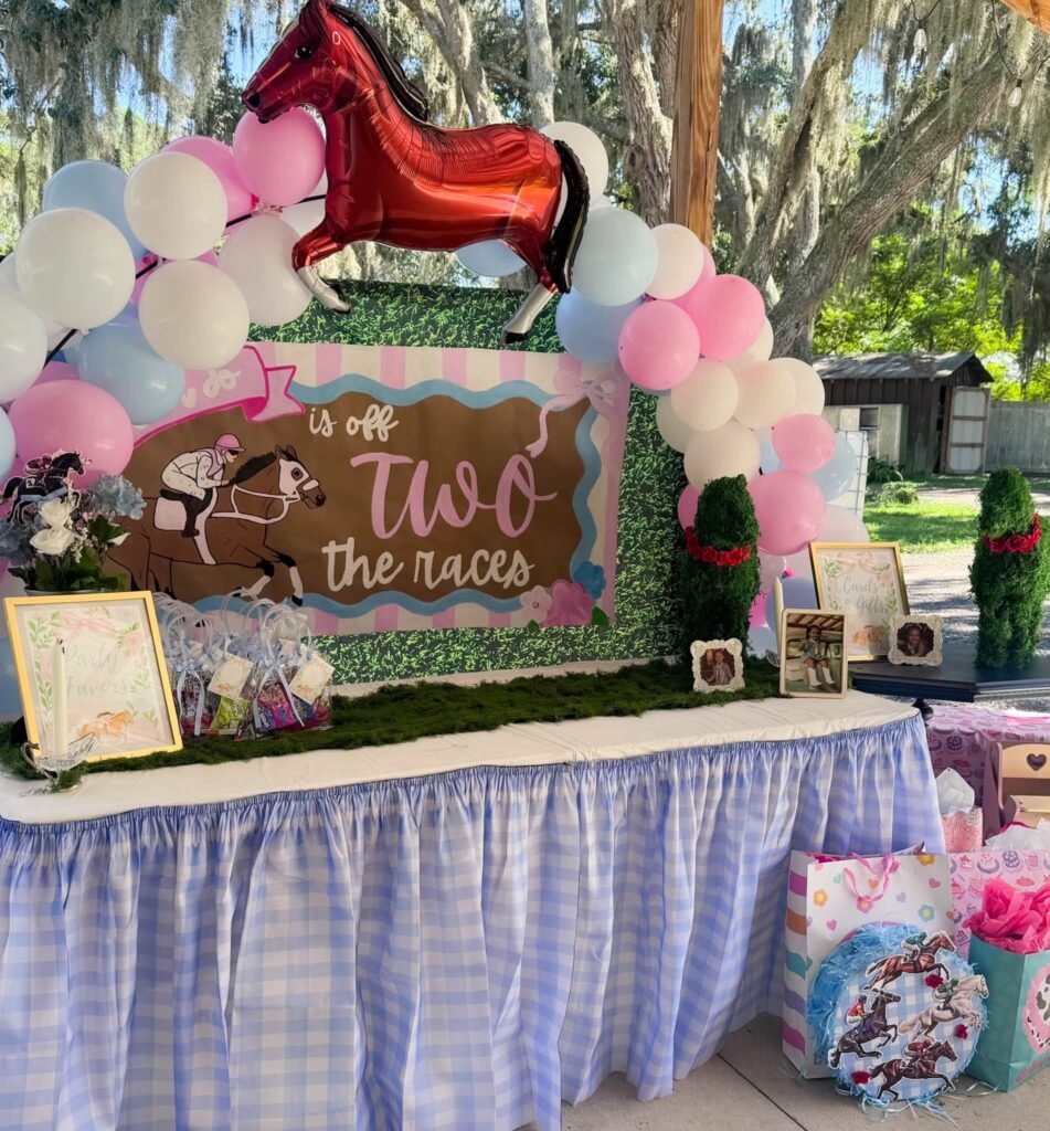 Off Two the Races 2nd birthday dessert table with a red horse balloon and pastel balloon garland