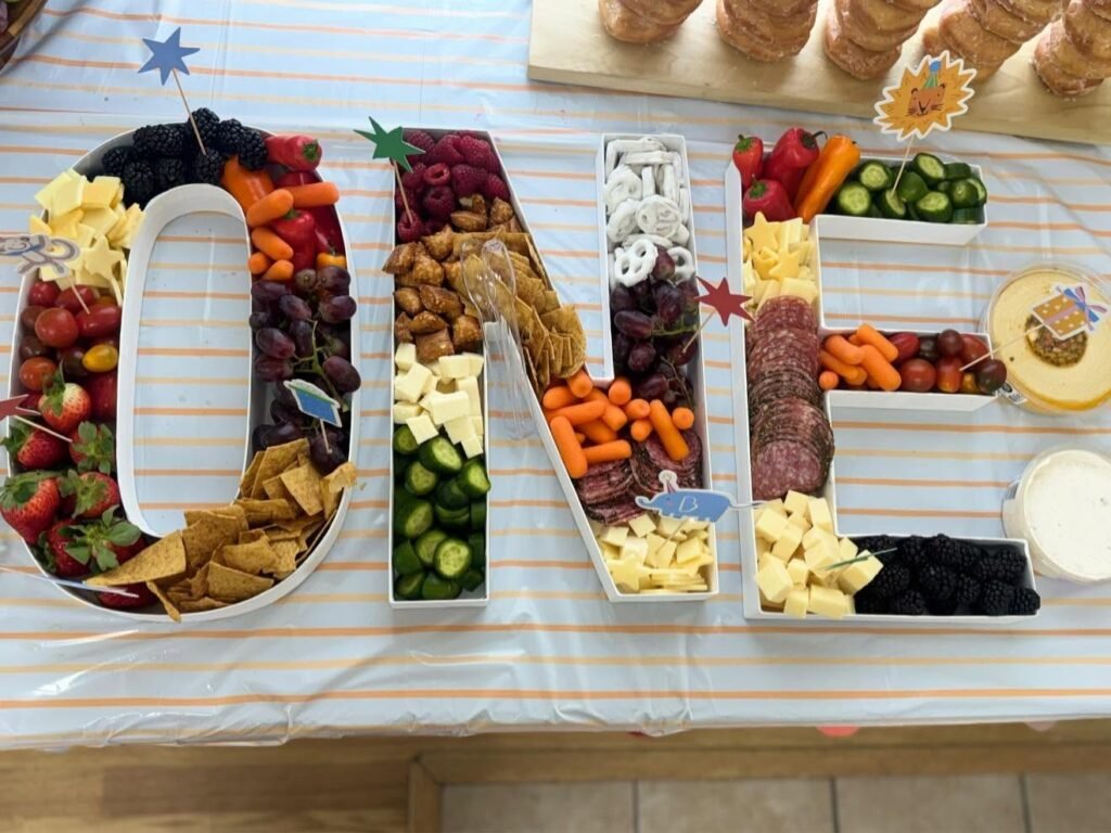 ONE shaped charcuterie board with fruit, cheese, crackers, veggies and meat
