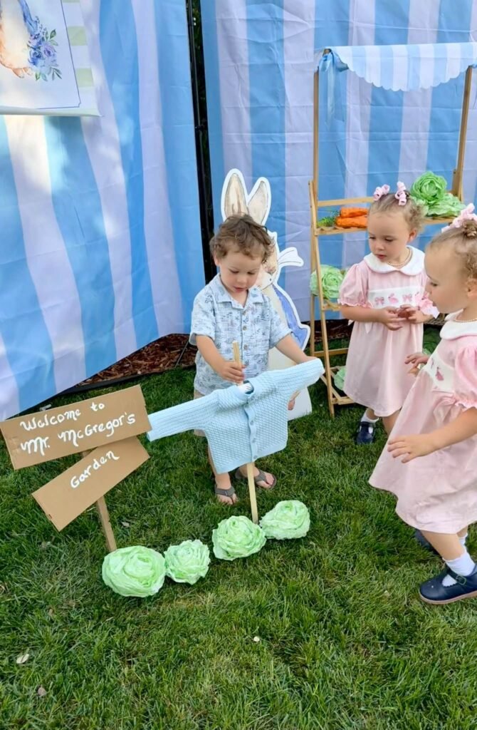 Toddlers in bunny ears exploring the Peter Rabbit garden backdrop