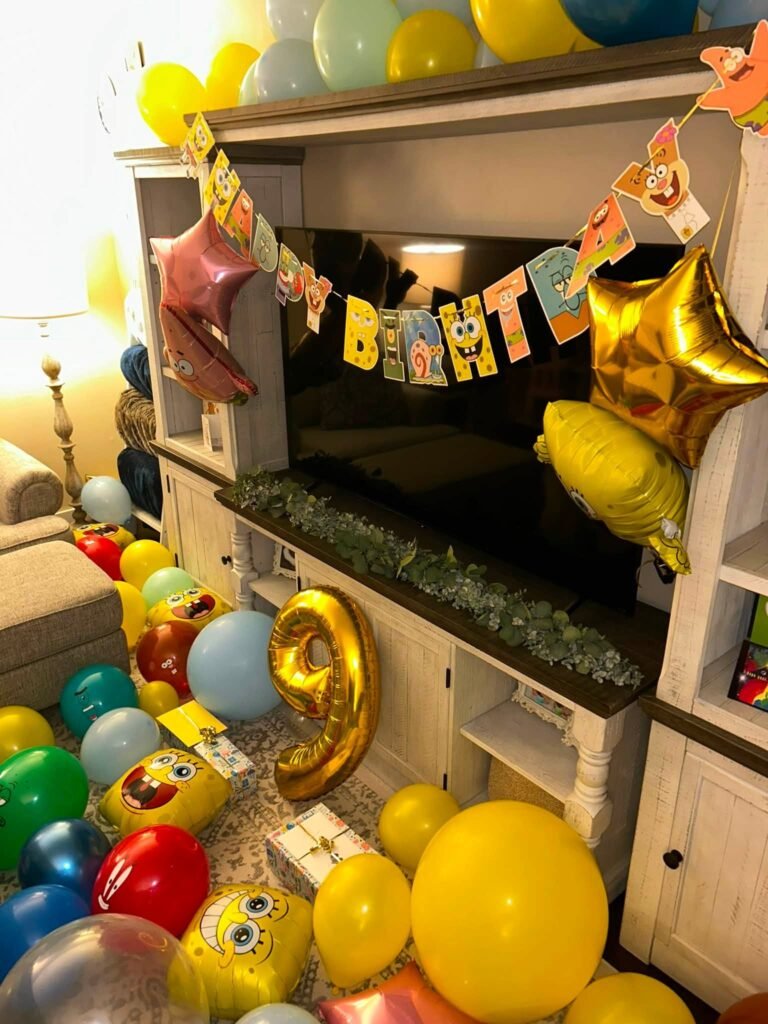 SpongeBob birthday decor with yellow and blue balloons, gold number 9 balloon and character banner