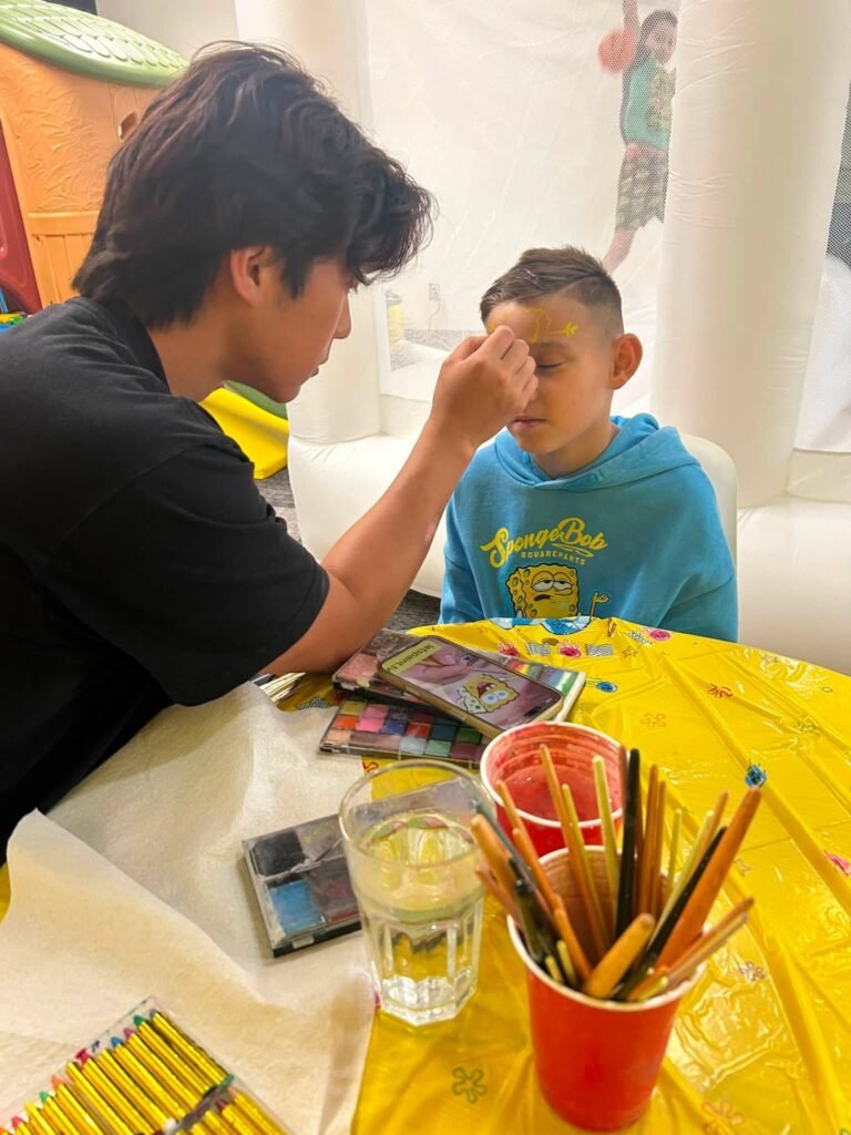 Face painting station at a SpongeBob birthday party