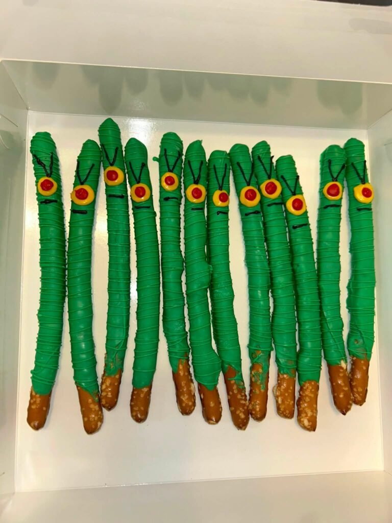 Green chocolate covered pretzel rods decorated like Plankton for a SpongeBob party