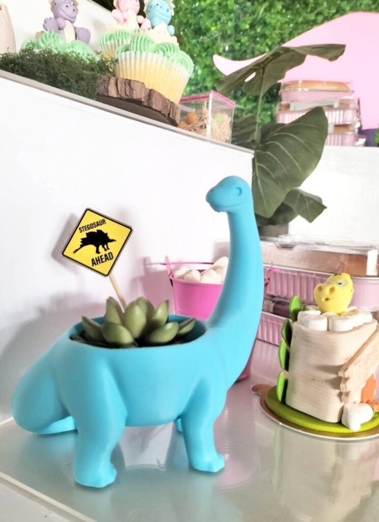 Blue dinosaur succulent planter with a dinosaur crossing sign as party decor