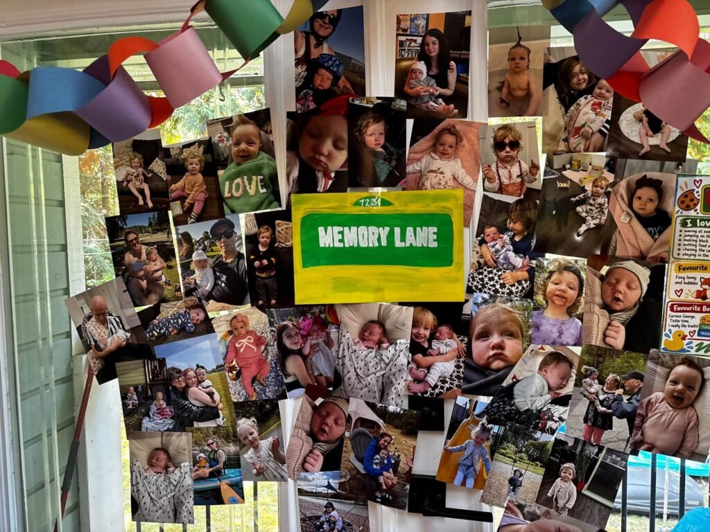 Memory Lane photo wall with family photos and a Sesame Street style sign