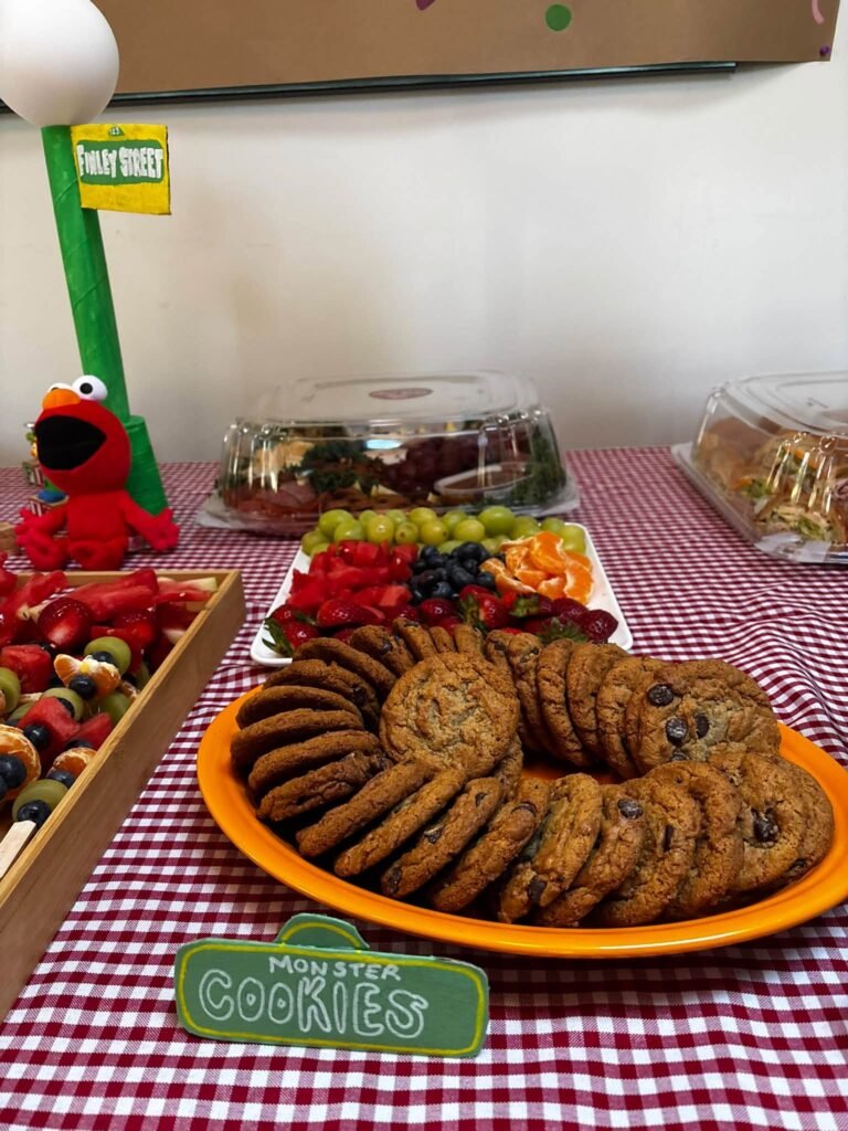 Cookie Monster cookies on an orange plate with an Elmo figure