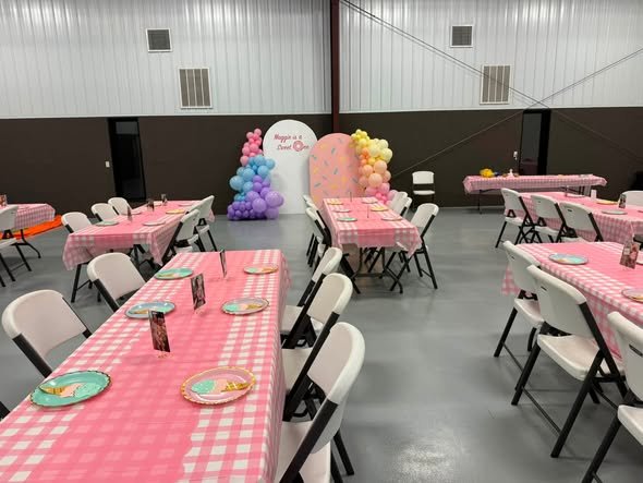 Party hall set with pink gingham tables for a Sweet One 1st birthday