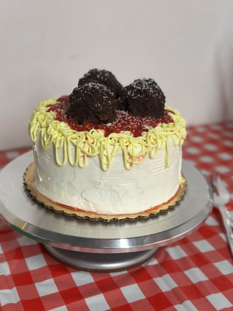 Spaghetti and meatball birthday cake with piped noodles and chocolate meatballs