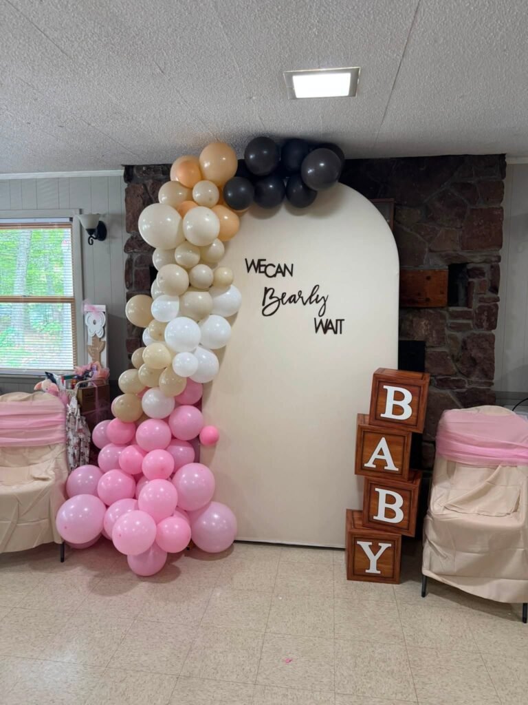 We Can Bearly Wait baby shower arch backdrop with a pink, cream and brown balloon garland and BABY blocks