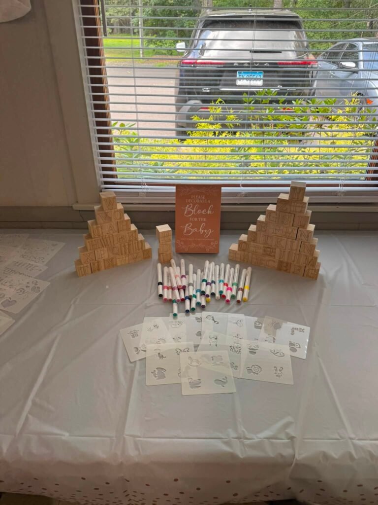 Baby shower activity table with coloring cards, markers and wood blocks