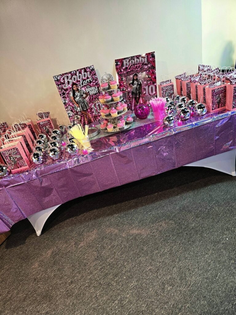 Pink metallic disco party favor table with cupcakes and custom treat bags