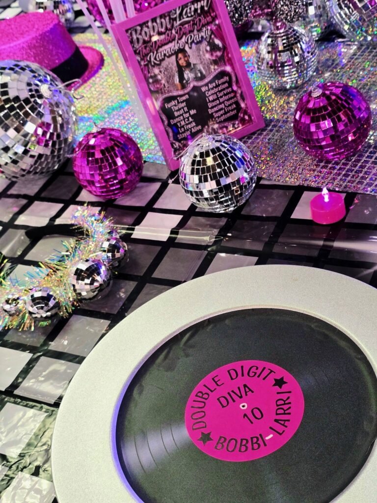 Vinyl record plate with a pink Double Digit Diva label and pink and silver disco balls