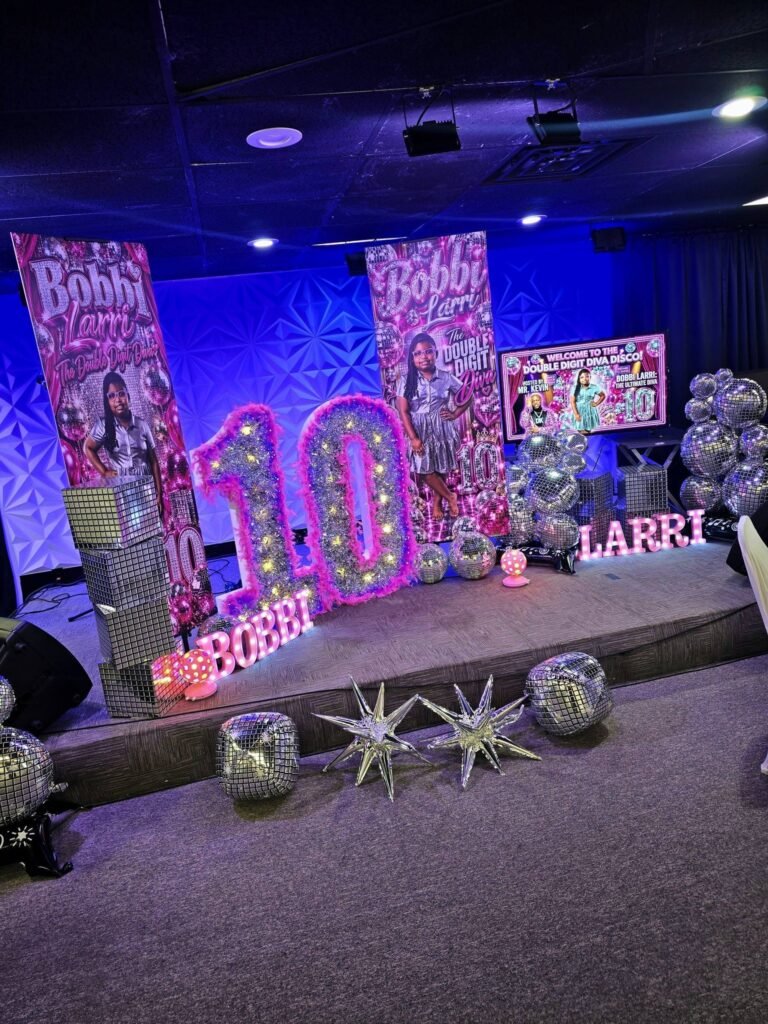 Disco party stage with light up marquee number 10, custom banners and disco balls