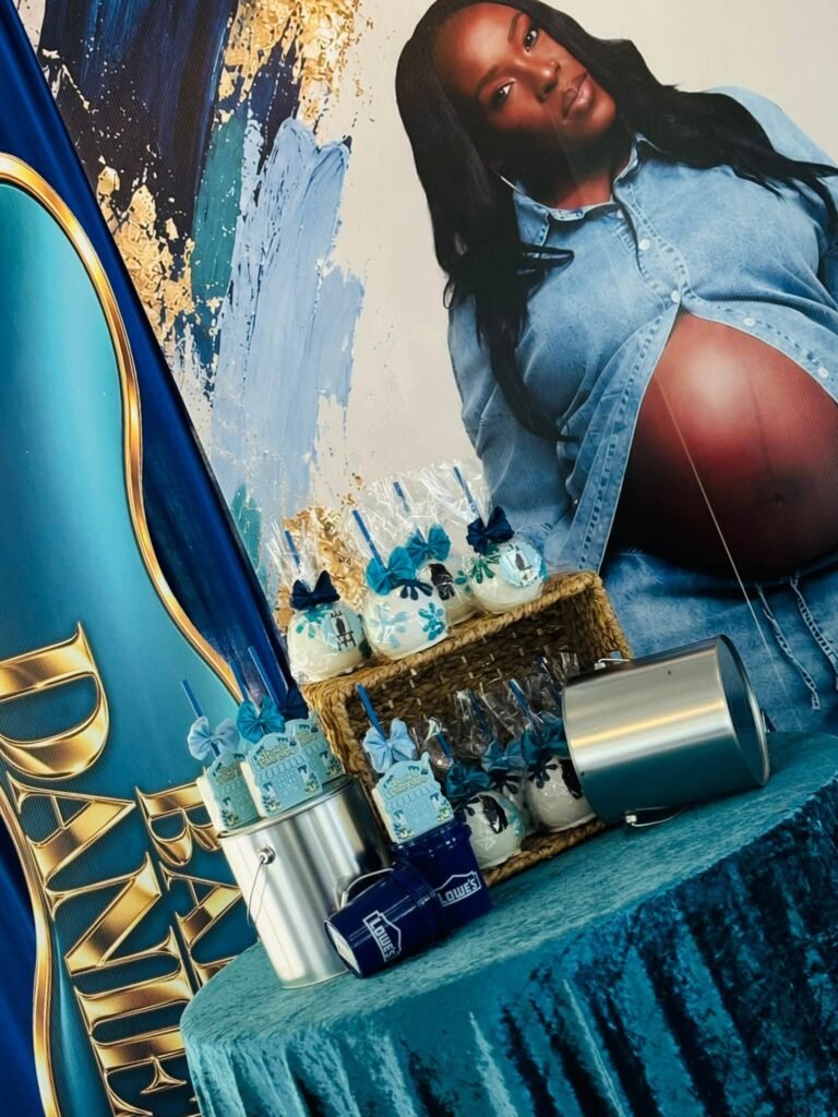 Large maternity photo print next to a navy and teal paint shop party table