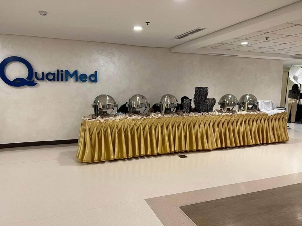 Buffet table with a gold pleated skirt and silver chafing dishes