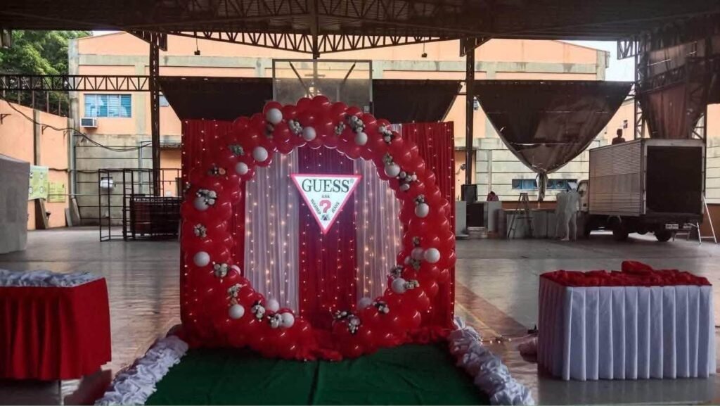 Red floral heart backdrop with a sparkly curtain in an event hall