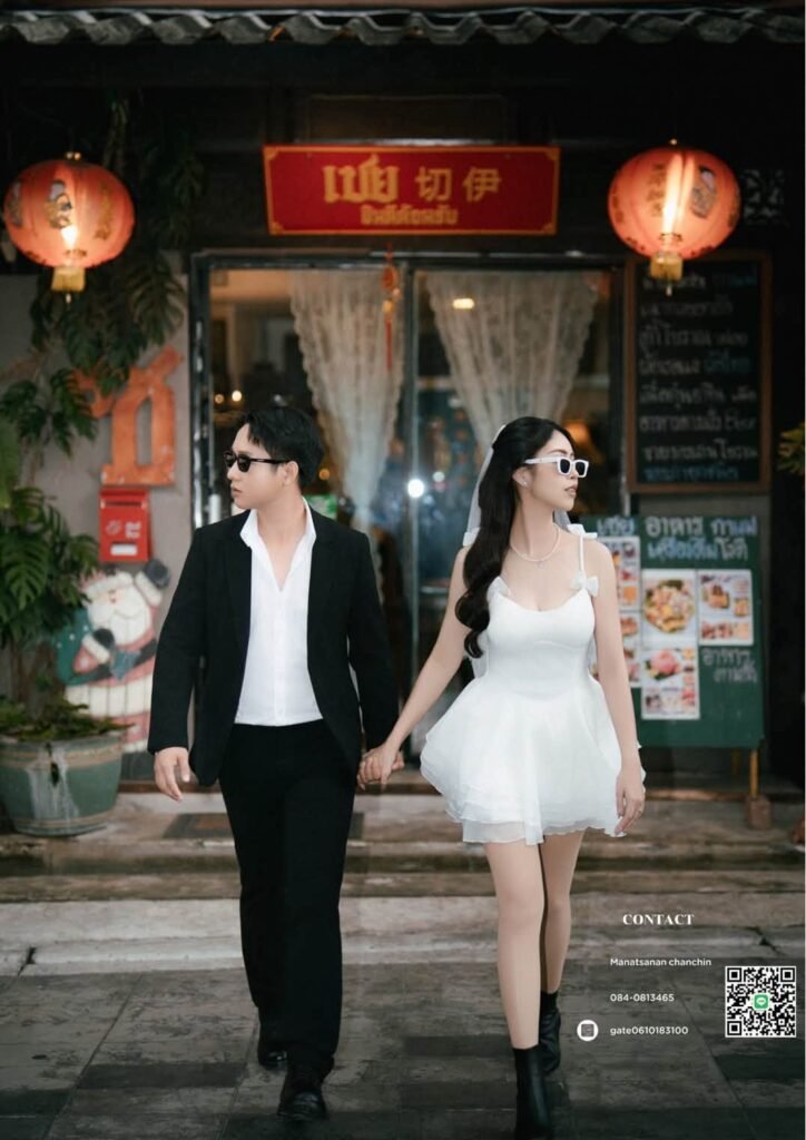 Couple in sunglasses walking out of a vintage shop, bride in a white mini dress and veil