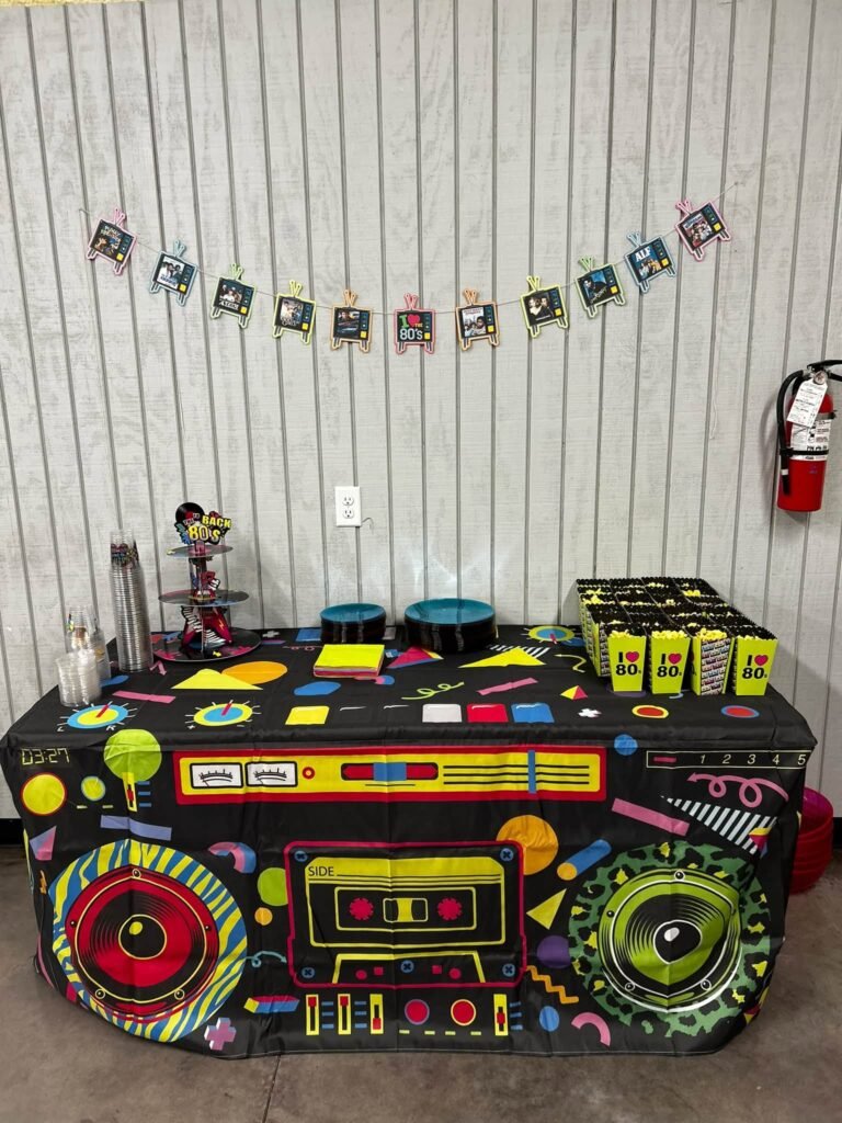 Giant colorful boombox prop under a birthday banner