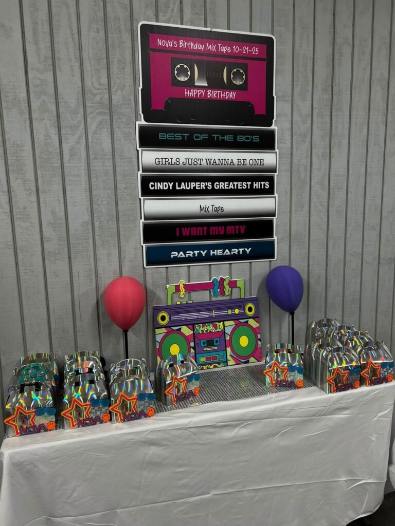 Cassette tape sign on a wall above a party table