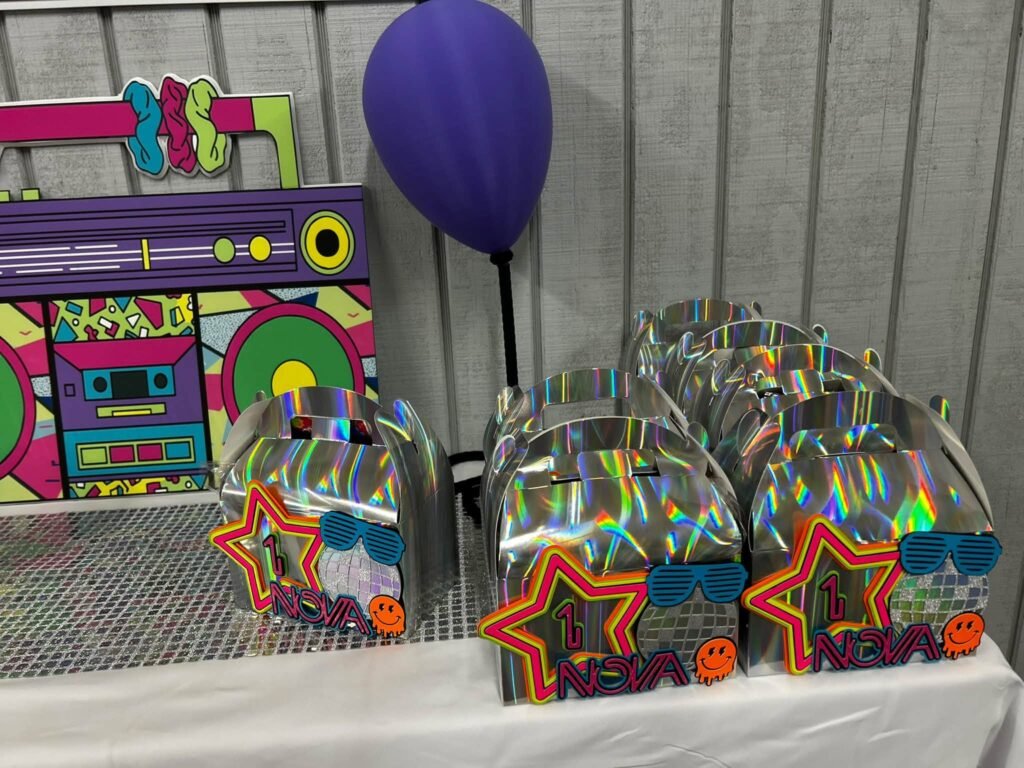 Neon boombox favor boxes on a table