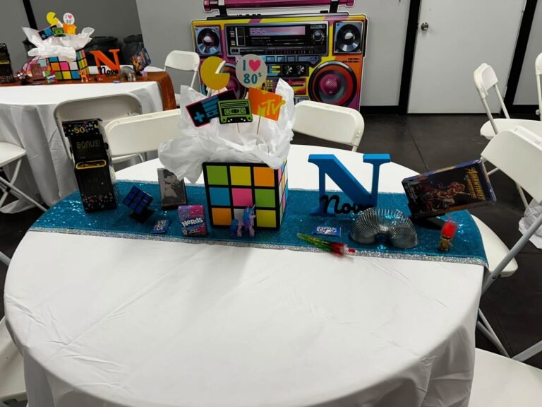 Round table with Rubik cube style centerpiece and a big letter