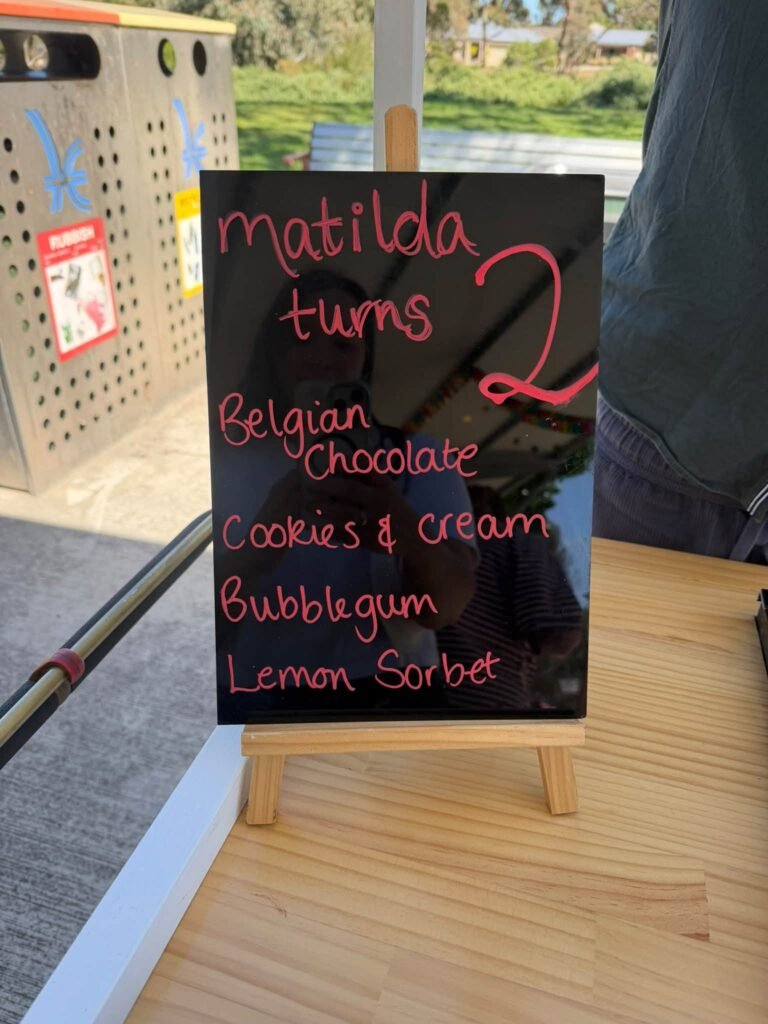 Chalkboard menu listing gelato flavors for a second birthday
