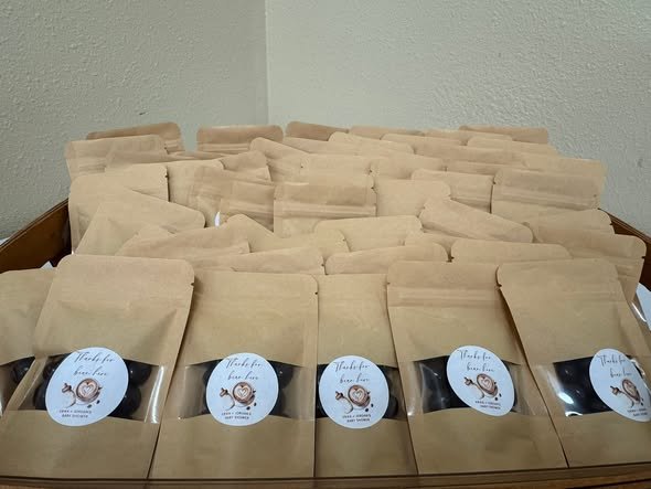 Close up of kraft coffee bag favors with round labels