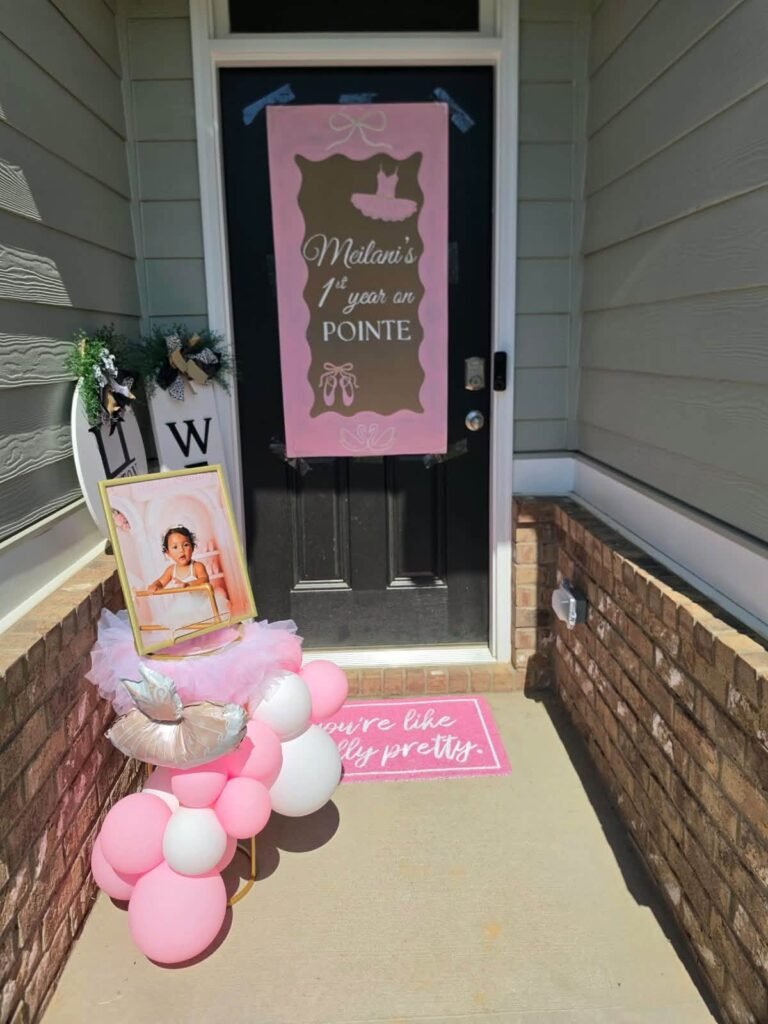 Front door with a pink ballet sign and pink balloons